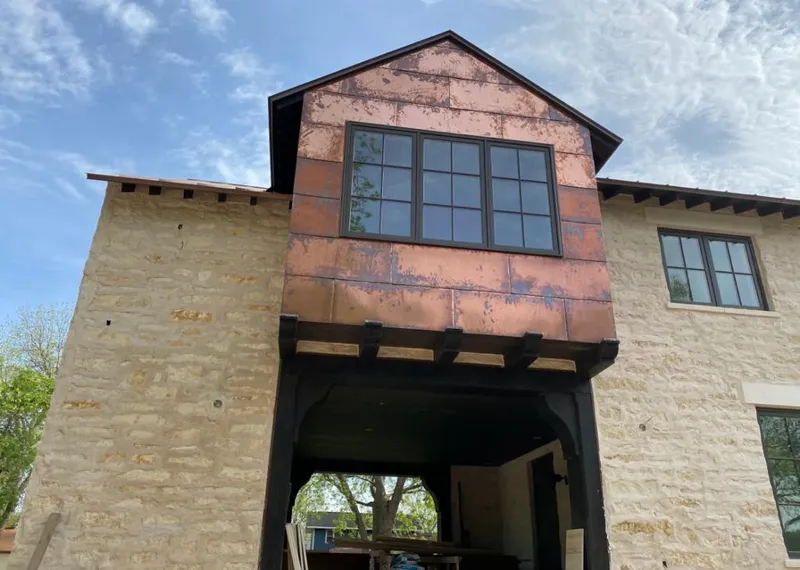 Copper metal panel facade on a stone building for Metal Roof Coating in Fenton